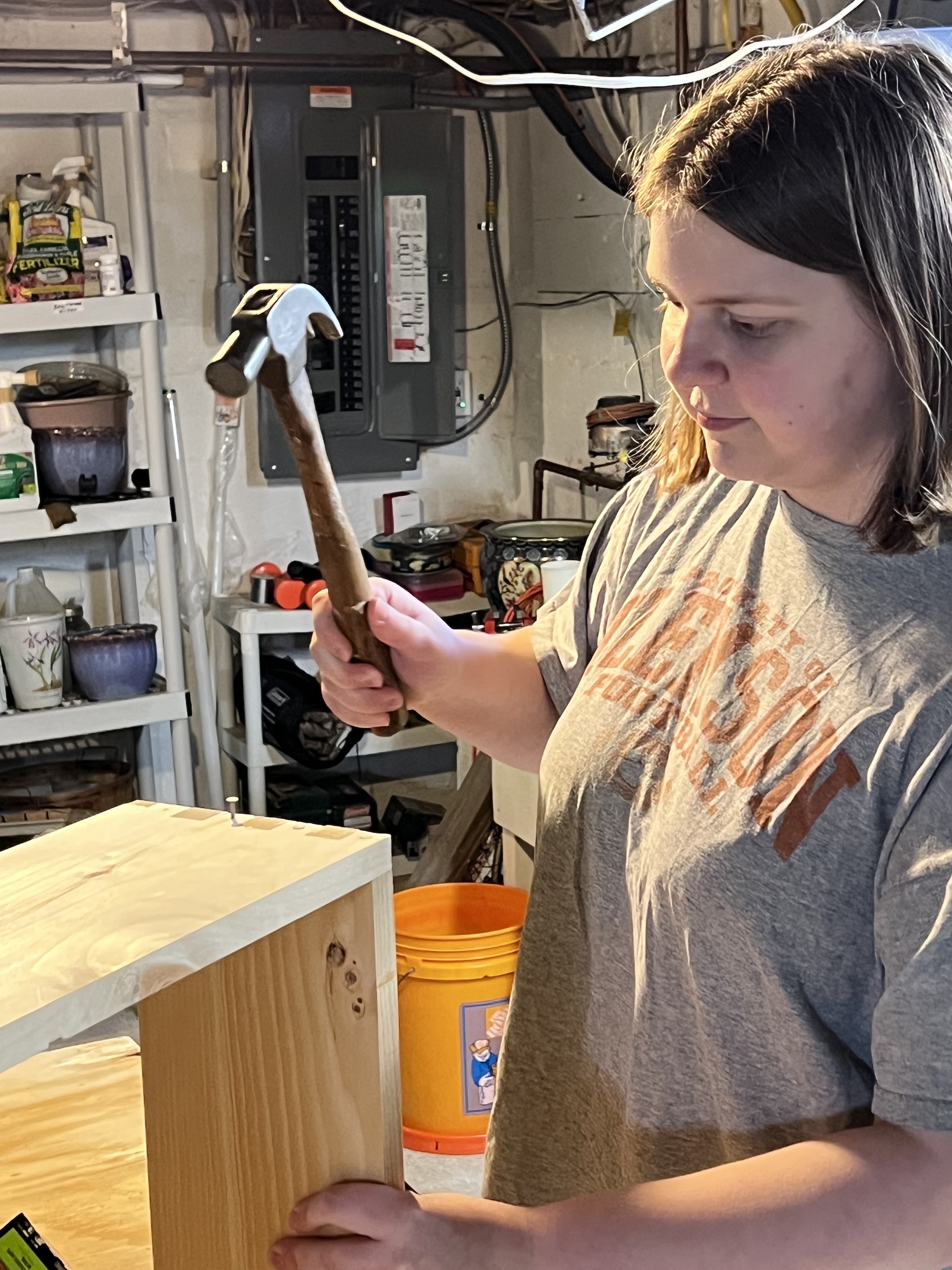 Young beekeeper assembling a hive body