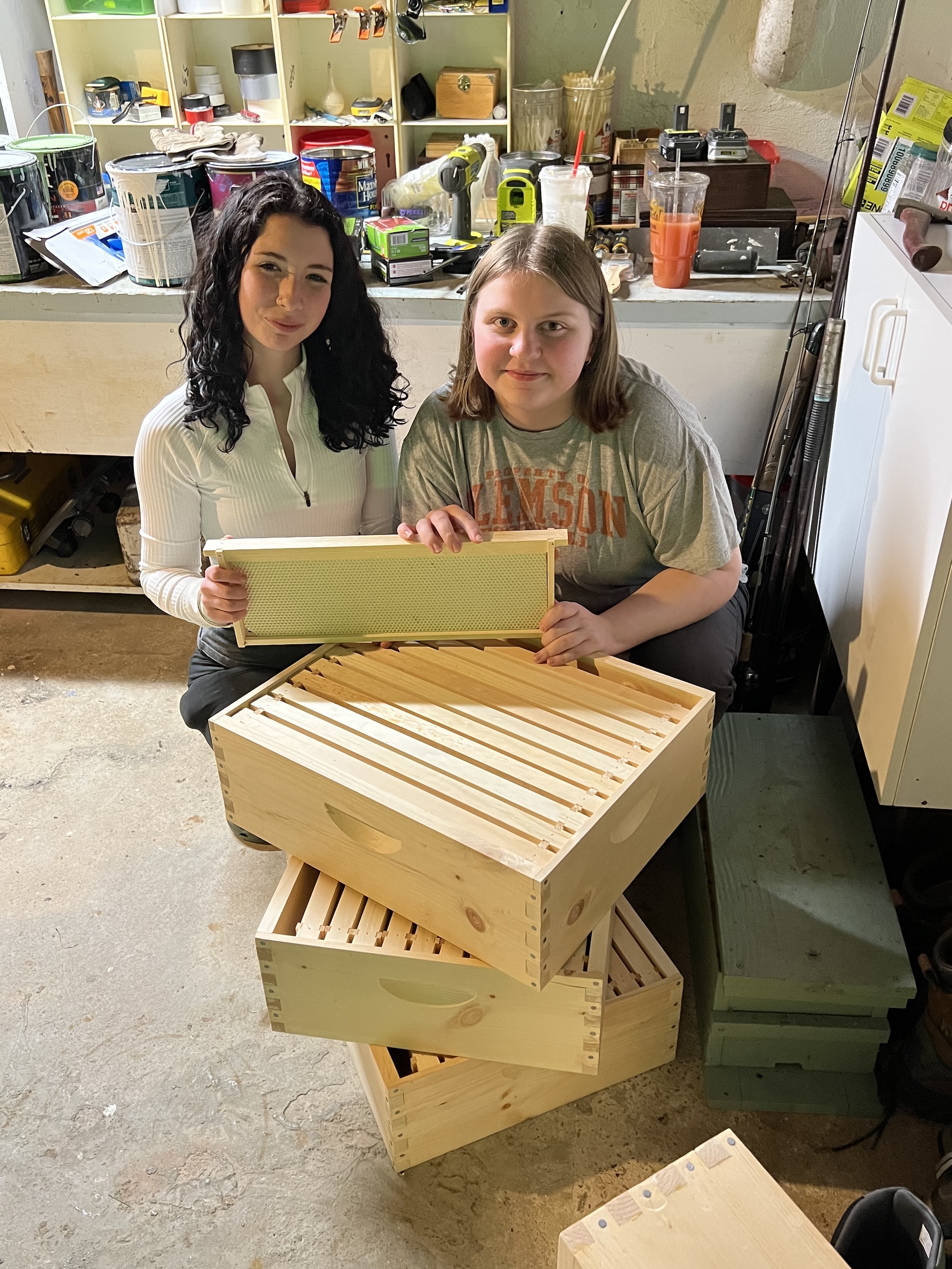 Trinity and Blakely, young beekeepers, with assembled woodenware